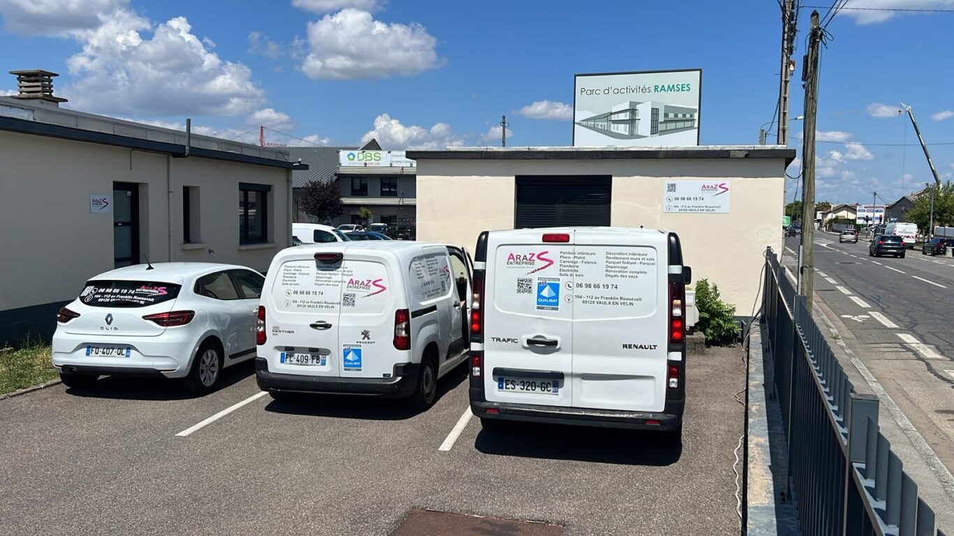 Photo des véhicules de la société Araz : une Renault Clio, un Peugeot Partner et un Renault Trafic.